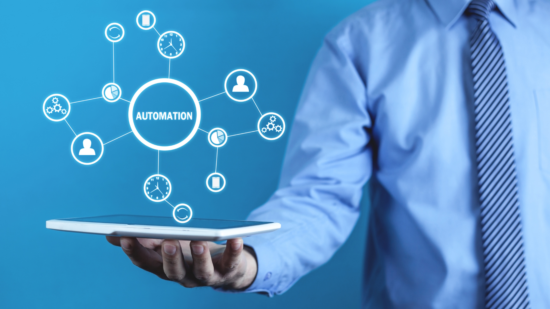 Businessman holding a tablet with automation icons connecting people, time, and workflow.