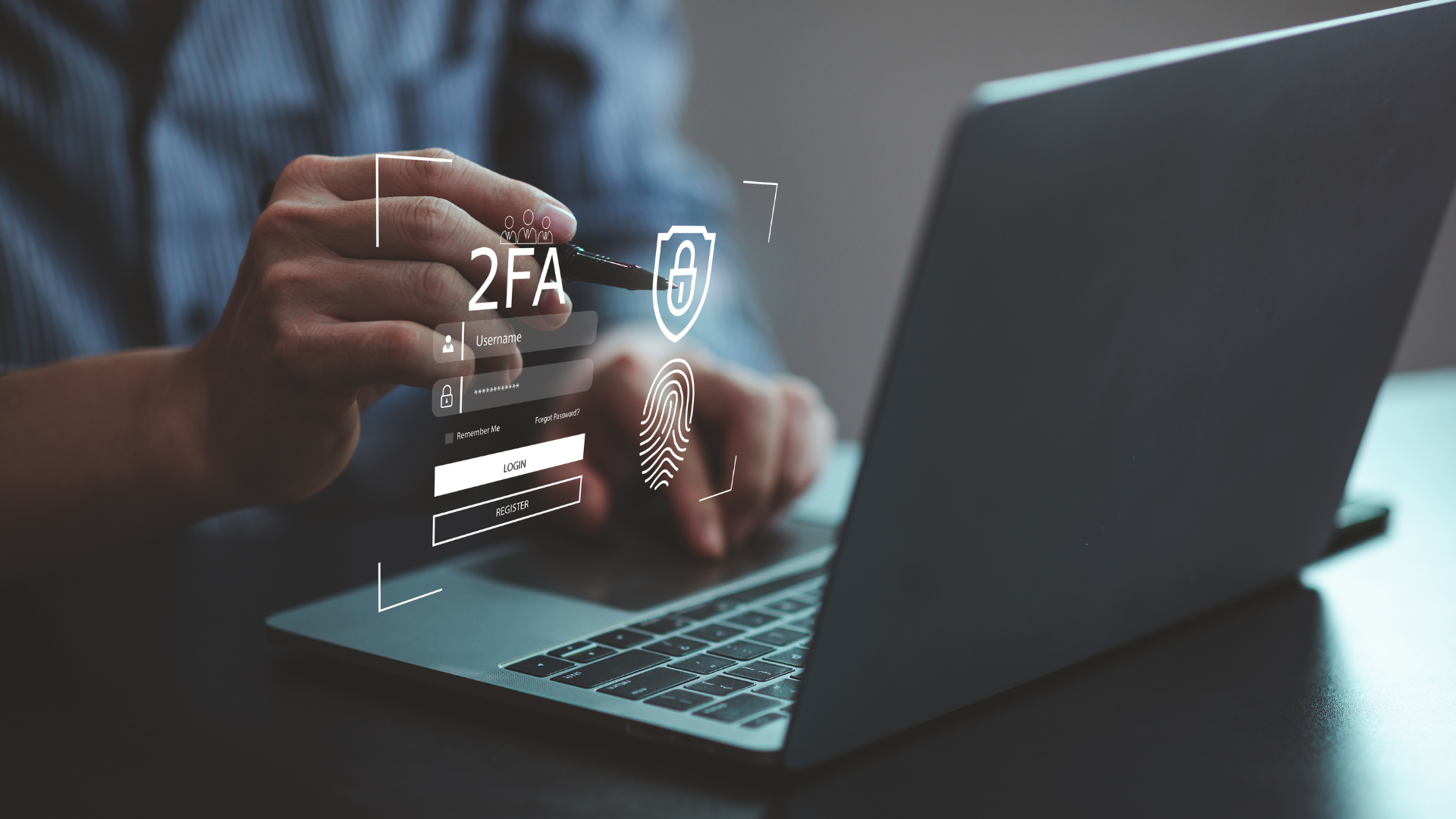 Person typing on a laptop with 2FA login and fingerprint security icons overlaid.
